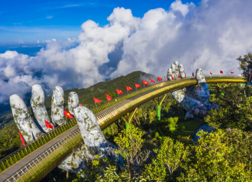 aerial view golden bridge is lifted by two giant hands two rows vietnamese flags ba na hill danang vietnam travel landscape concept