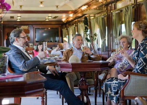 people drinking wine on luxury train
